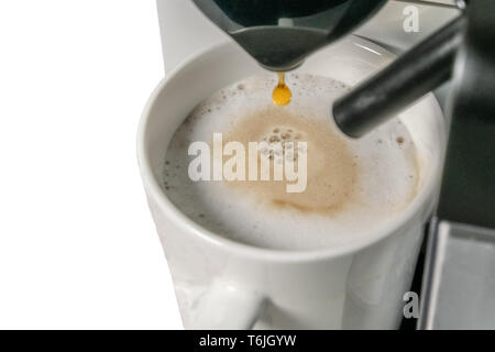 https://l450v.alamy.com/450v/t6jgyw/making-cappuccino-close-up-view-of-espresso-pouring-from-a-coffee-machine-cappuccino-has-the-main-ingredients-are-espresso-and-milk-t6jgyw.jpg