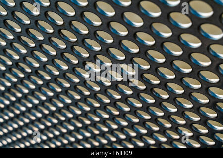 Metal hole mesh pattern with shallow depth of focus background Stock Photo