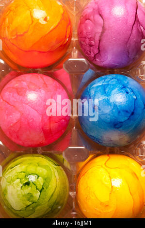 colourful painted Easter eggs in plastic container Stock Photo