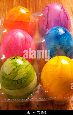 colourful painted Easter eggs in plastic container Stock Photo