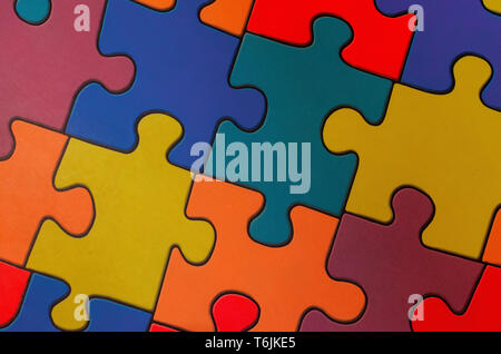 Fragment of a floor in a children's game room from multi-colored puzzles Stock Photo