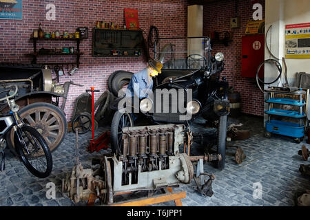 An Old Model Car On The Garage With The Rust And Damage On The