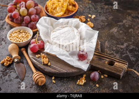 Cheese with honey, nuts and grapes Stock Photo