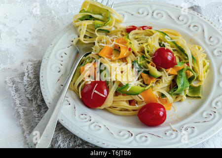 Italian pasta with vegetables, parmesan and lemon zest. Stock Photo