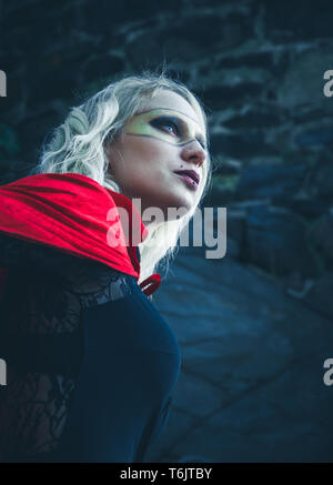 Angled view of woman wearing cape and mask Stock Photo