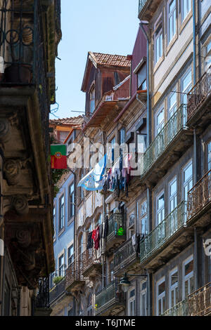 traditional narrow street in Porto, Portugal with washing hanging from the balconies Stock Photo