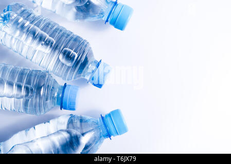 Several drinking water bottles on white background. Eco concept. Copy space for your text. Stock Photo