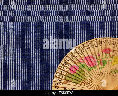 vintage Chinese wood fan on table cloth Stock Photo