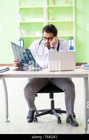 Doctor radiologist looking at x-ray scan in hospital Stock Photo