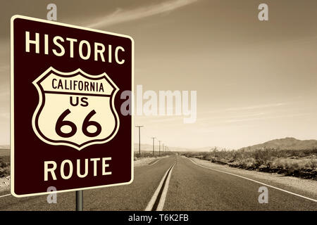 Route 66 road sign with a background  view of Tthe Mother Road (Route 66) in the in the Mojave Desert in California Stock Photo