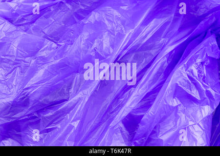Abstract texture of purple cellophane garbage bag. macro close-up background. Stock Photo