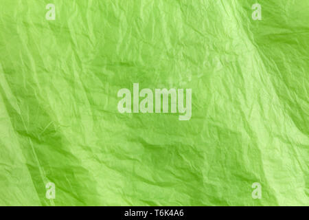Abstract texture of green cellophane garbage bag. macro close-up background. Stock Photo