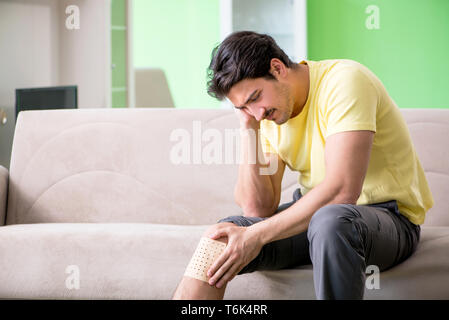 Man applying pepper Capsicum plaster to relieve pain Stock Photo