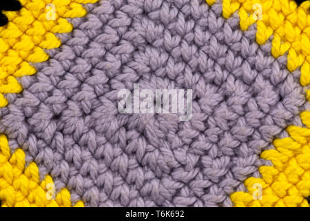 Abstract texture of a knitted fabric gray macro background with close-up. Stock Photo