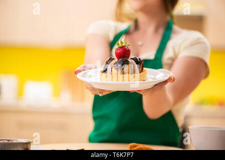 The young cook cooking cakes in the kitchen Stock Photo