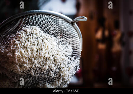 Sieve with cheese. Close-up. Stock Photo