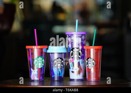 BANGKOK, THAILAND - 15 November, 2017: Starbuck souviniers arranged in the line on the wood table with blur background, to present the holiday gift to Stock Photo