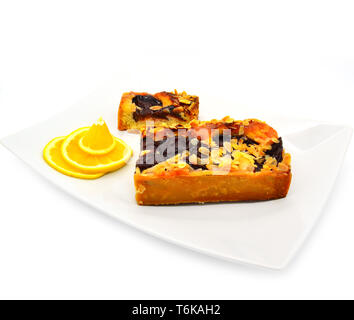 sliced plum pie with almonds on a white background. Stock Photo