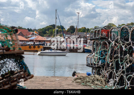 A abstract view of a modern sail boat in the water between 2 objects to give it depth of view. Stock Photo