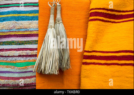 Textured background of brightly colored fabrics in bold stripes with metallic tassels Stock Photo