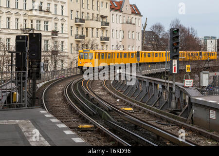 Old yellow U-Bahn subway train approaching an overground station in Berlin, Germany. Stock Photo