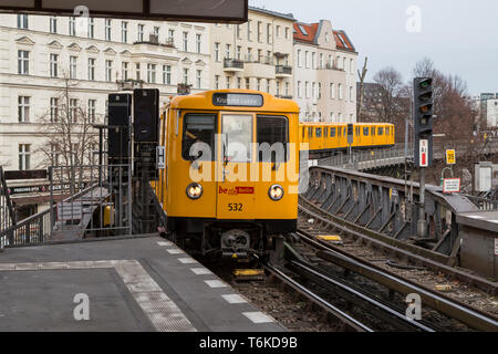 Old yellow U-Bahn subway train approaching an overground station in Berlin, Germany. Stock Photo