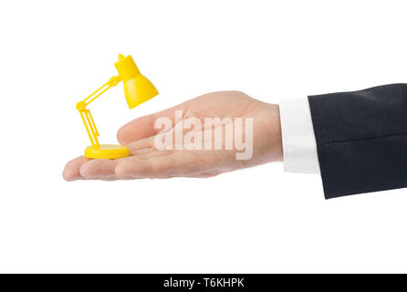 Hand with small desk lamp Stock Photo