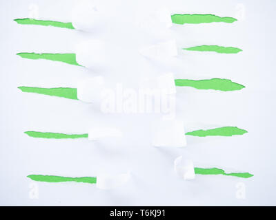 Torn white paper isolated on green Stock Photo