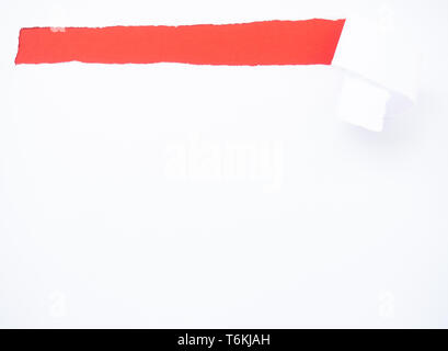 Torn white paper isolated on red Stock Photo
