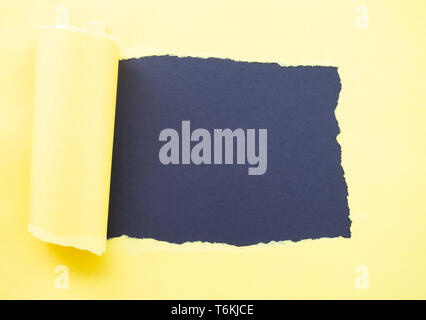 Torn yellow paper isolated on black Stock Photo