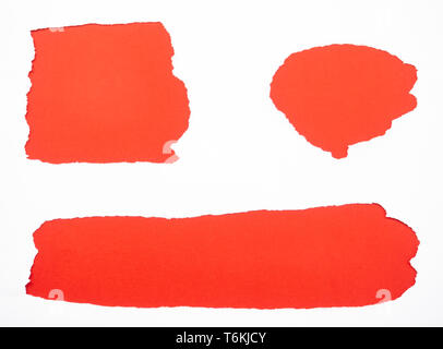 Torn white paper isolated on red Stock Photo