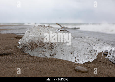 Abstract Outdoor Elements Frozen Ice Block Sandy Beach Trail Waves Background Stock Photo