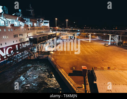 Editorial 03.29.2019 Mariehamn Åland. MS Rosella moored in the empty port at night seen from the leaving MS Silja Symphony Stock Photo