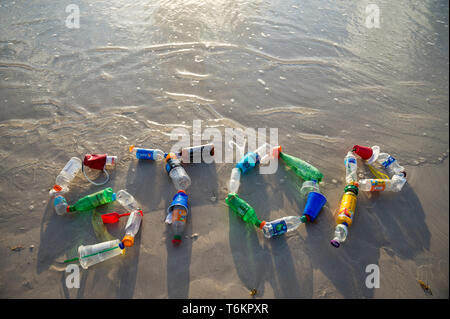 MIAMI - JULY, 2018: 'Stop' spelled out in the sand using garbage collected on Miami beach and in the sea as a message for action on plastic pollution. Stock Photo