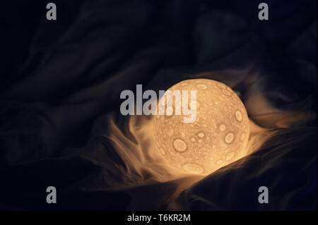 decorative moon lamp in bed Stock Photo