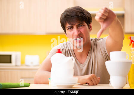 Man washing dishes at home Stock Photo