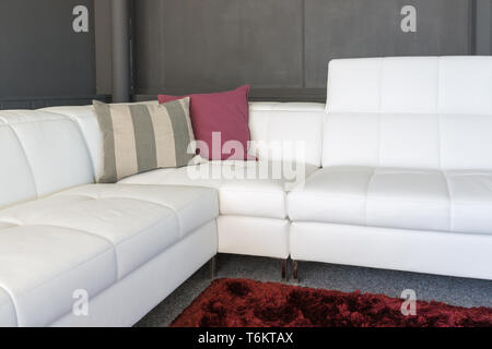 Couch with white upholstery and pillows Stock Photo