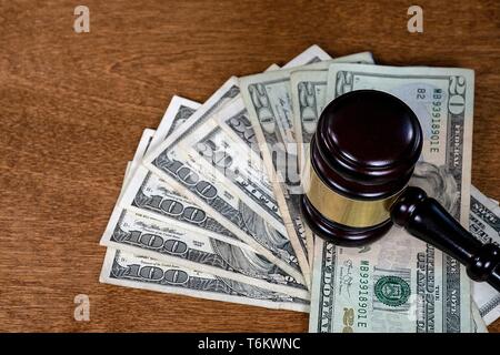 judicial court gavel with American money on wooden surface Stock Photo