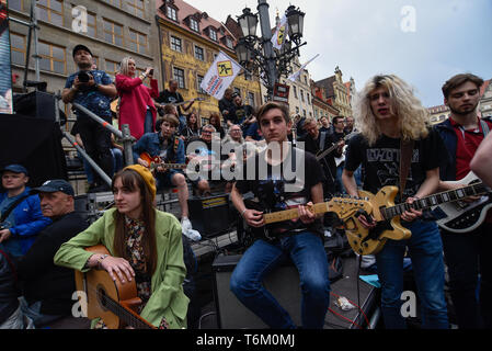 A mass gathering of guitarists seen attempting  to beat the Guinness record for ensemble guitar playing at the Main Square.  According to the organizer, reports say 7243 musicians gathered in Wroclaw Market Square to play Jimi Hendrix's hit 'Hey Joe'. Stock Photo