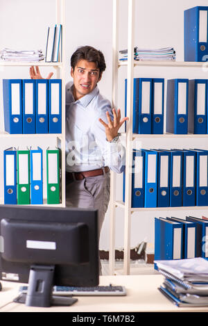 Young male employee working in the office Stock Photo