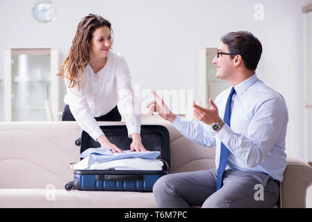 Wife seeing her husband off to business trip Stock Photo