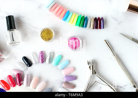 Set of various manicure and pedicure tools and accessories on white marble background. Top view. Stock Photo