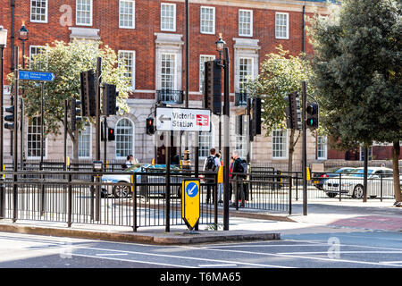 London, UK - September 15, 2018: United Kingdom Westminster neighborhood district with sign directions to Victoria station train railway