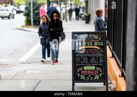 Asheville, USA - April 19, 2018: People on sidewalk by bus cafe restaurant outside on a street serving coffee drinks and desserts in North Carolina ci