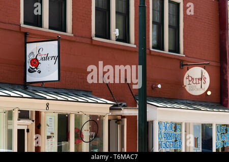 Asheville, USA - April 19, 2018: Downtown old town street in North Carolina NC famous town city with restaurant store shop closeup of signs exterior o Stock Photo