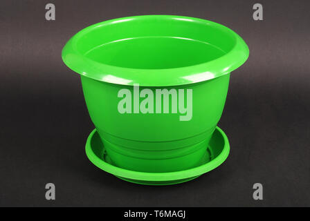 Green Plastic Flower Pots on Black Background Stock Photo