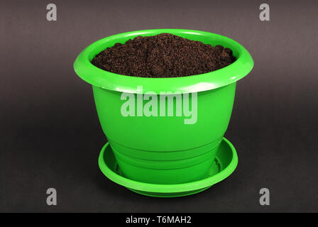 Green Plastic Flower Pots on Black Background Stock Photo