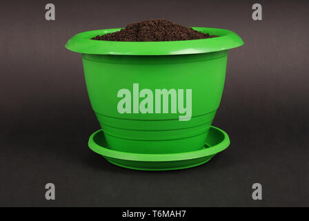 Green Plastic Flower Pots on Black Background Stock Photo