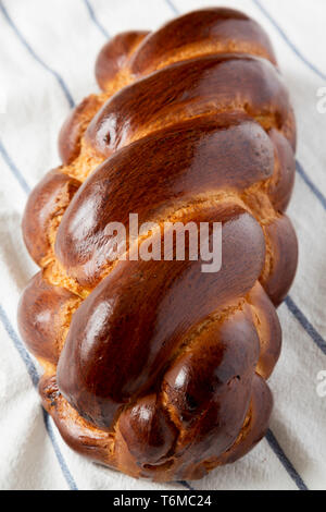 Homemade jewish challah bread on cloth, side view. Closeup. Stock Photo