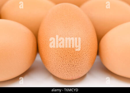 Close up of a fresh egg with others in the ackground Stock Photo